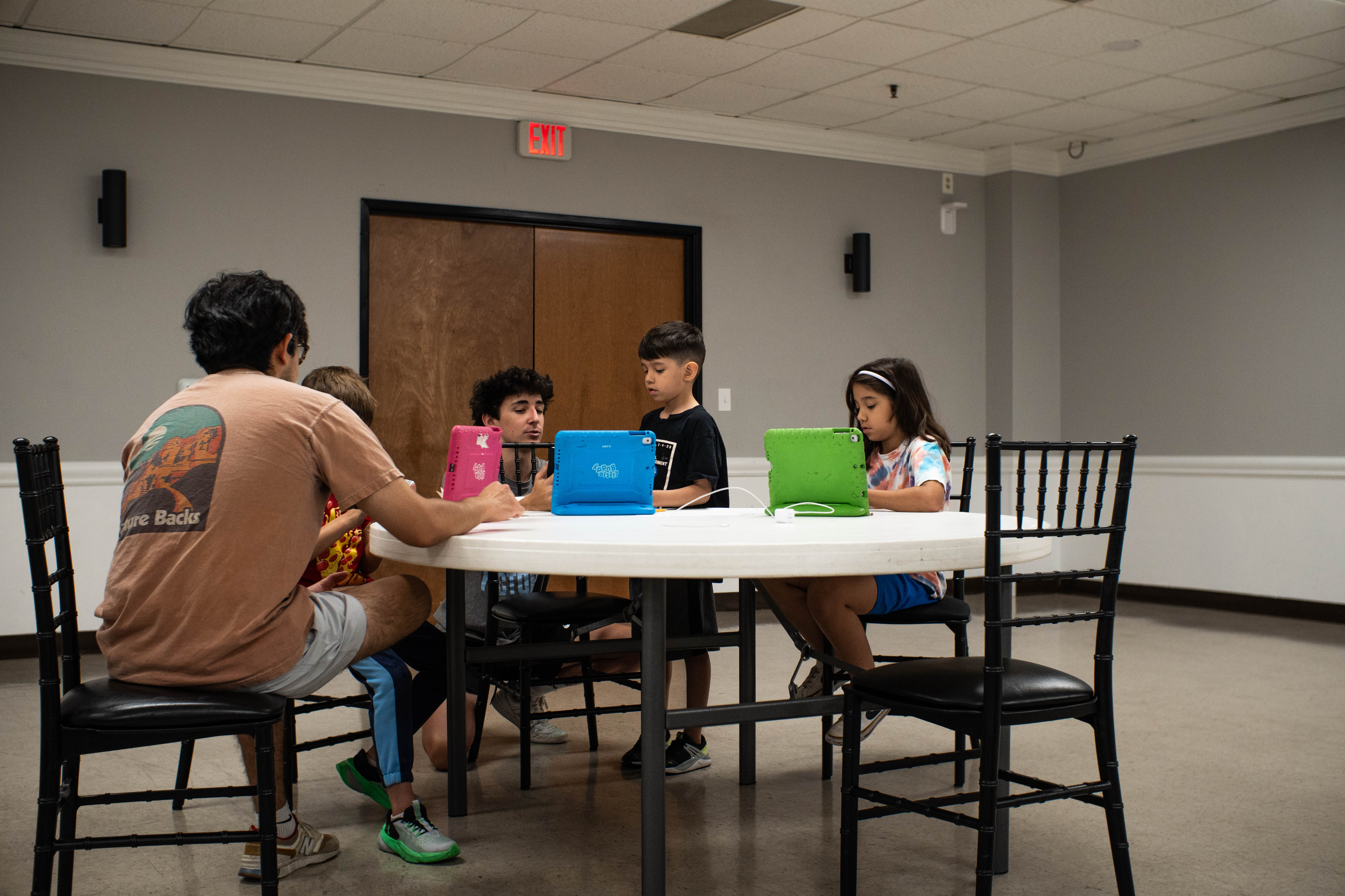 Instructors Isi Martinez and Nash DeHaven work with students on their ideas for their videos.