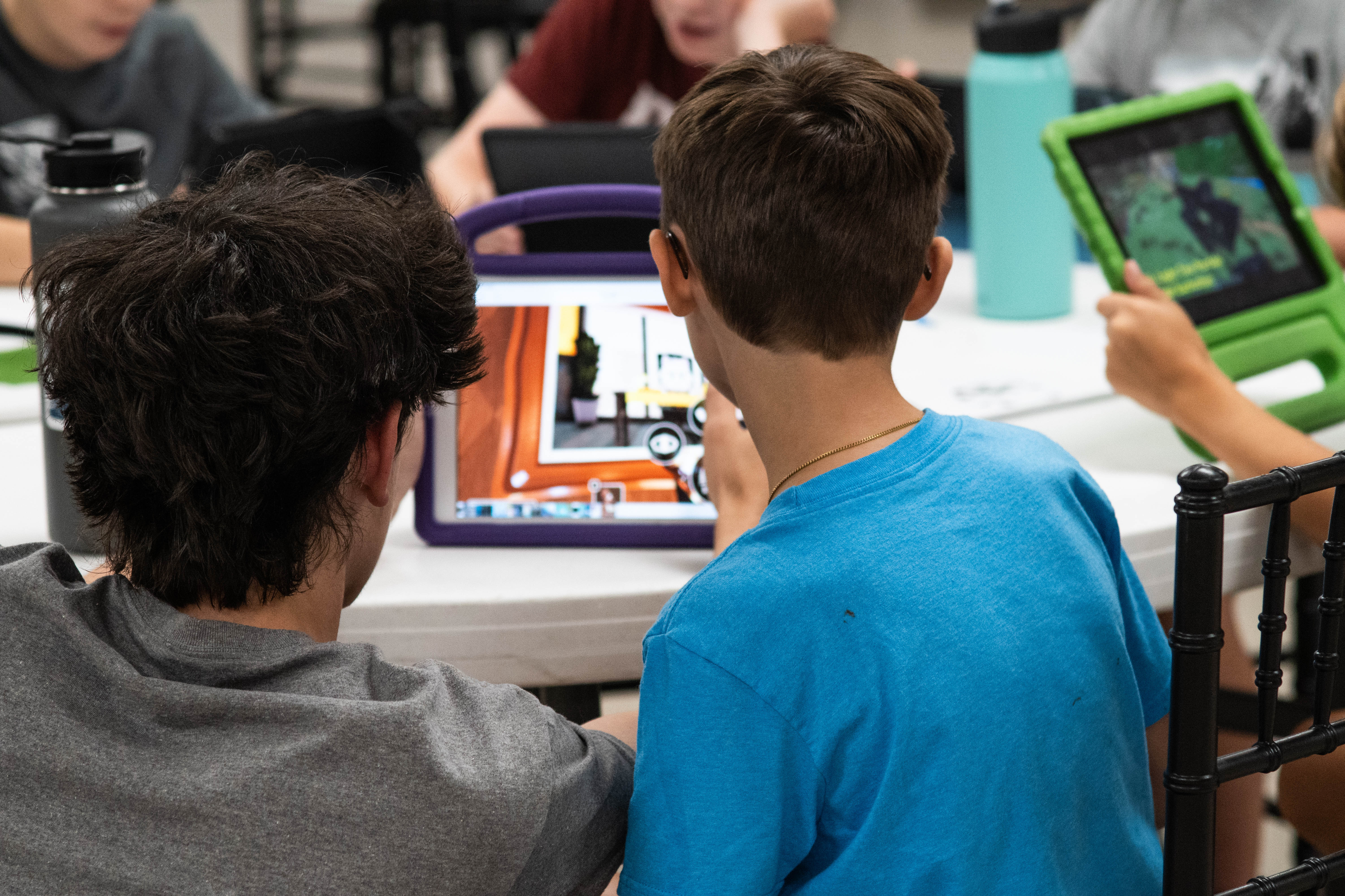 Instructor Nash DeHaven and a student studying gameplay. 