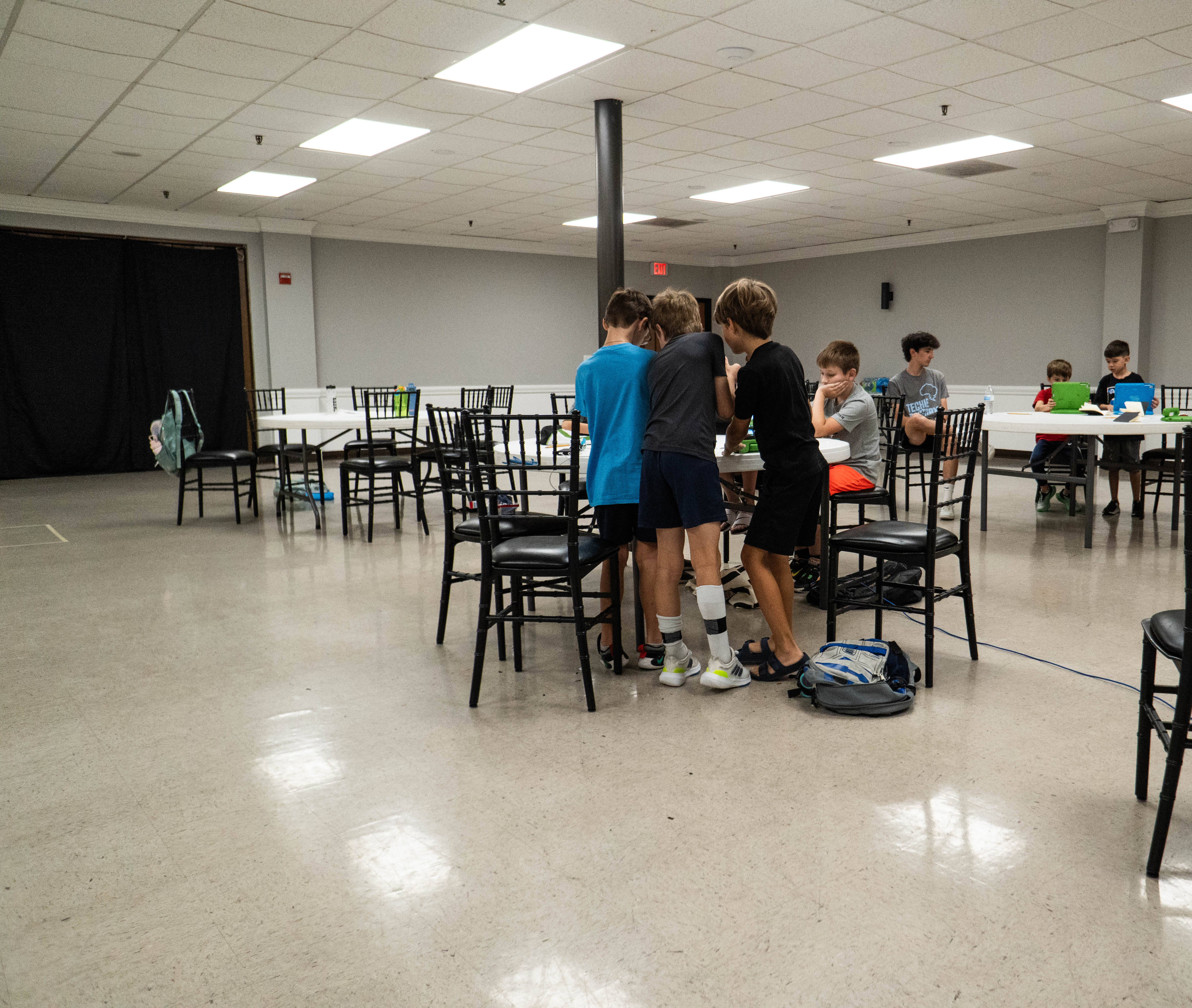 Techie Factory students gather together to watch one student's video. 